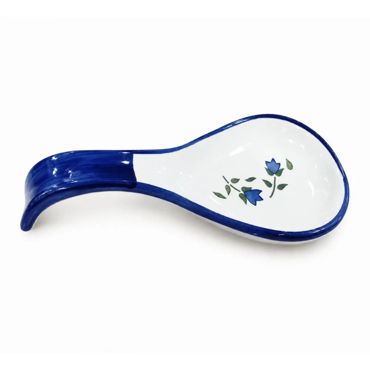 Blue and white ceramic spoon rest with floral design on a white background