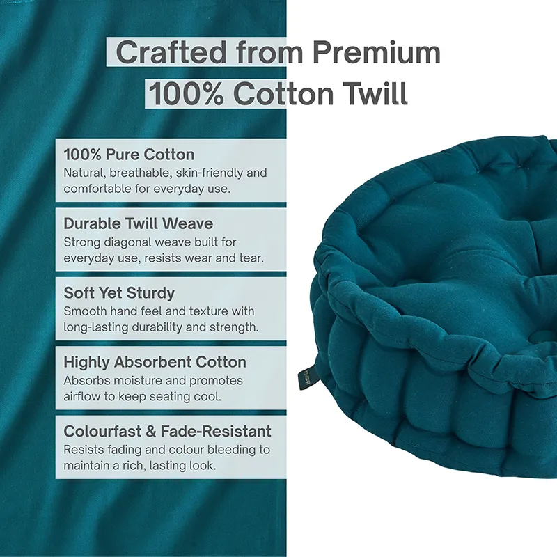 Close-up of a botanical green cotton floor cushion with a softly textured surface.