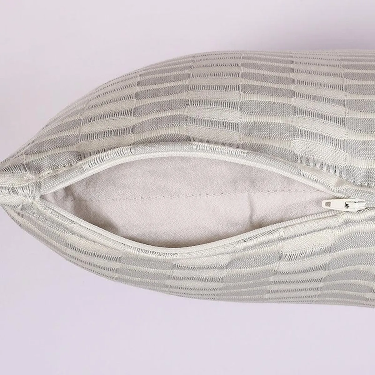 Close-up of the cushion cover edge with zip opening visible
