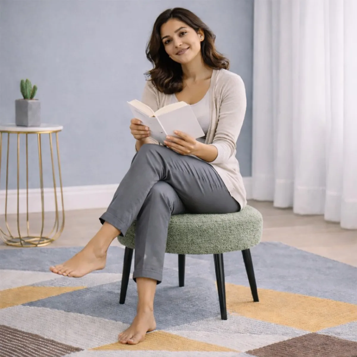 Person seated on a round sage bouclé stool with black legs