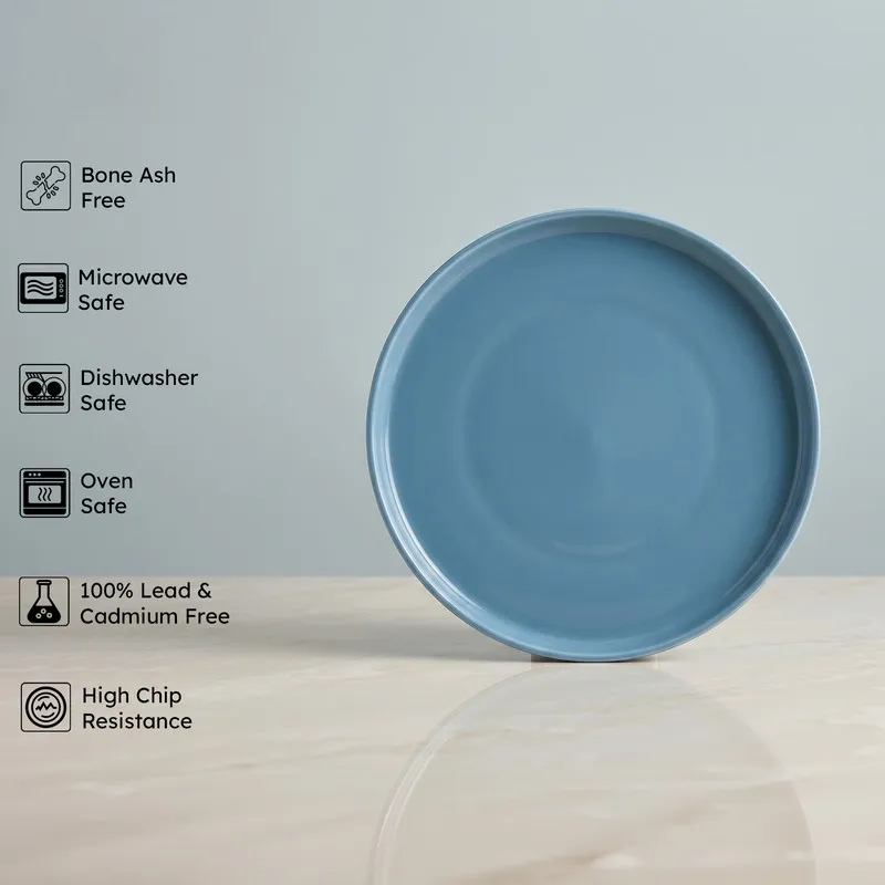 Single glossy blue round plate against a plain backdrop