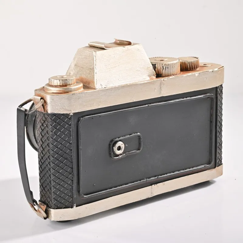 Rear view of vintage camera showpiece in black and silver finish