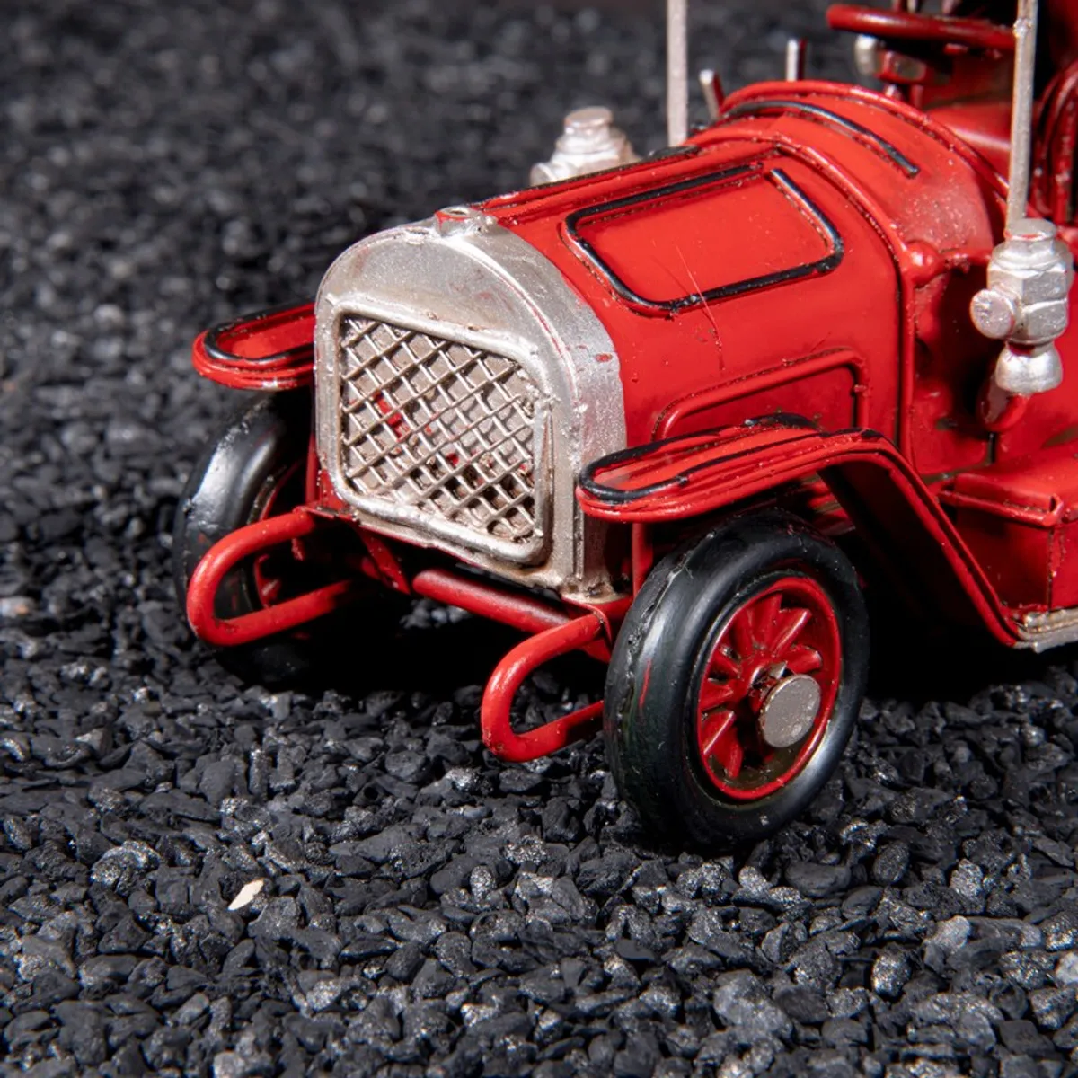 Close-up of the front grille and wheel of the red car showpiece