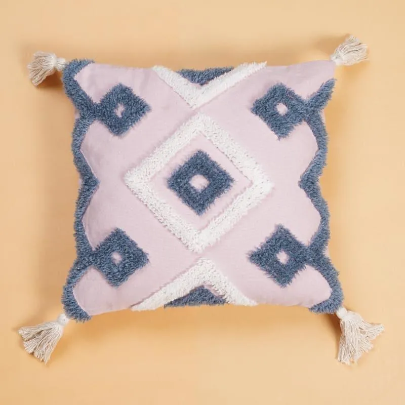 Front view of a pink square cushion cover with tufted grey and white diamonds and tassels