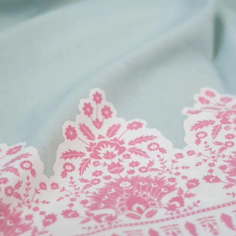 Close-up of pink floral print and soft aqua curtain fabric