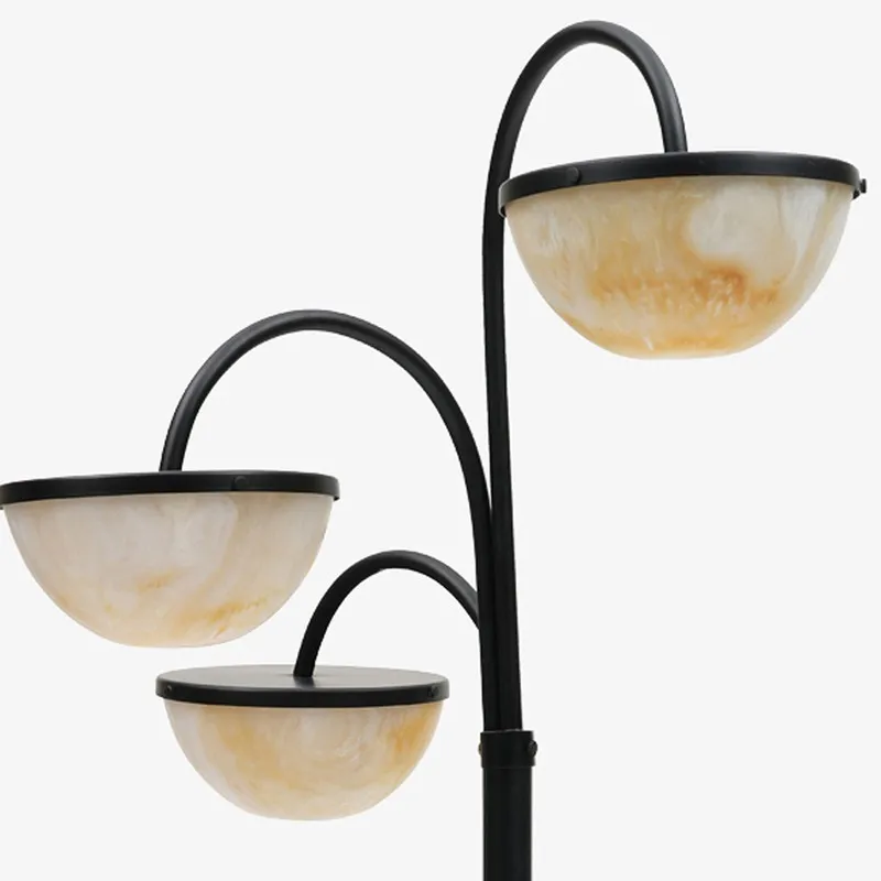 Upper section of black floor lamp with three curved arms and bowl shades