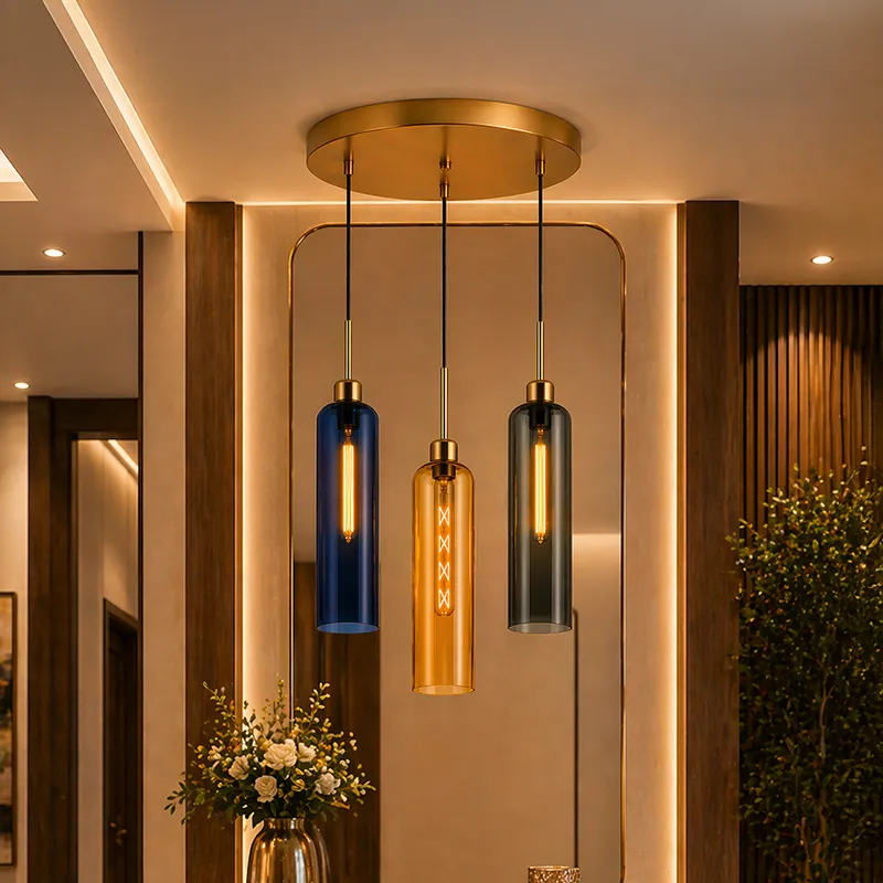 Modern clustered ceiling lamp with three cylindrical glass pendants and a round gold canopy