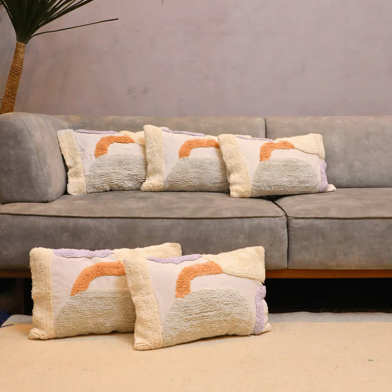 Five tufted rectangular cushion covers arranged on a grey sofa