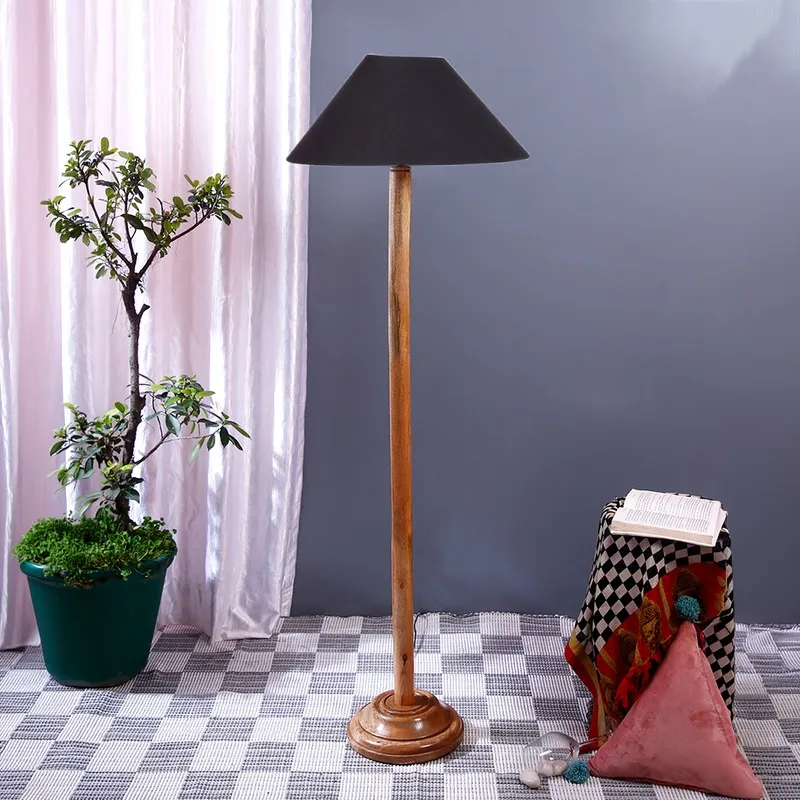 Dark walnut floor lamp with black shade against a soft grey backdrop