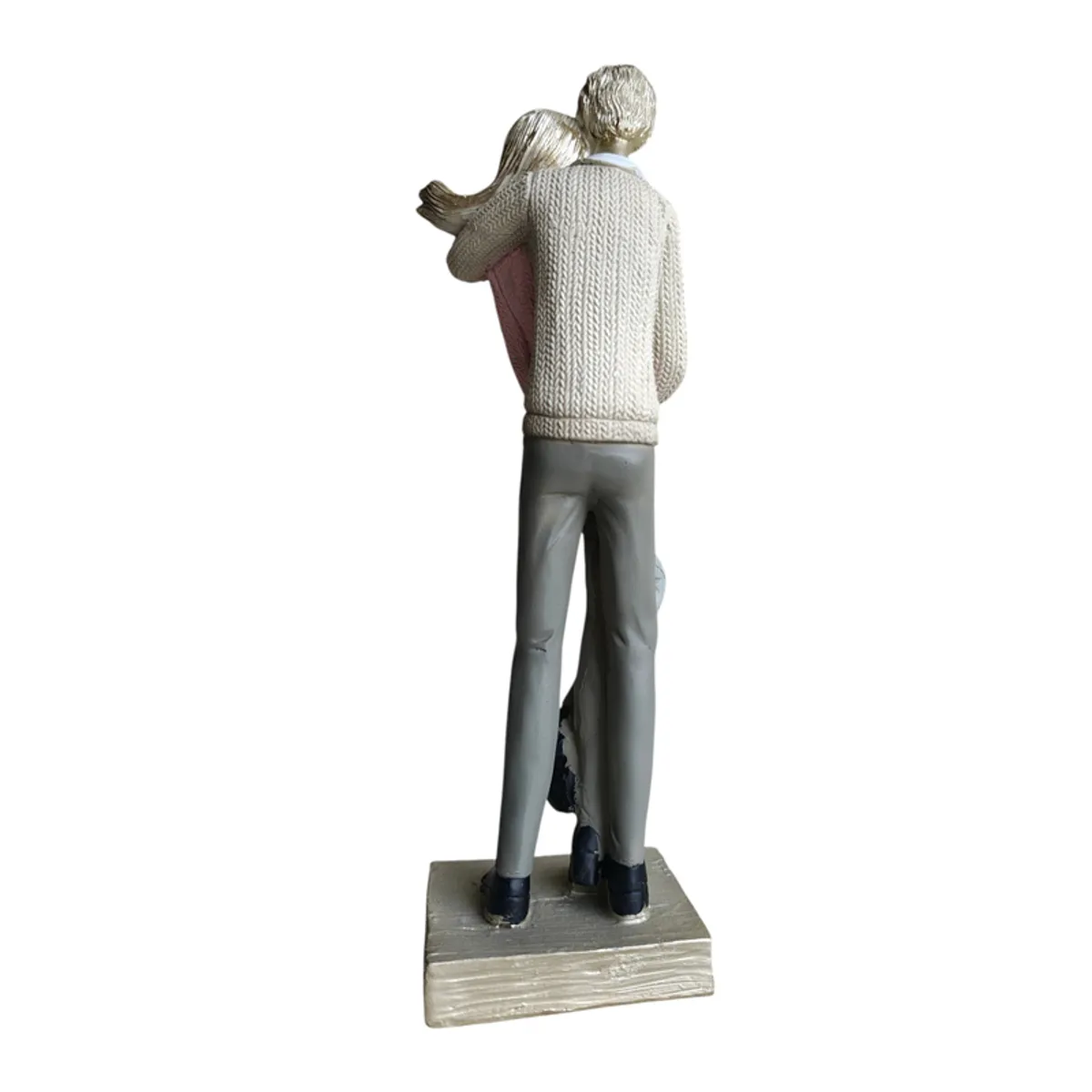 Back view of the couple sculpture showing its gold-toned details